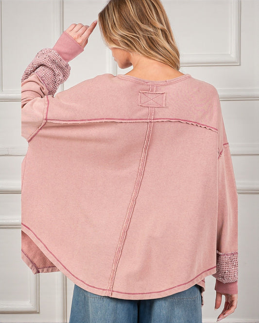 Person wearing a pink denim jacket with a white background