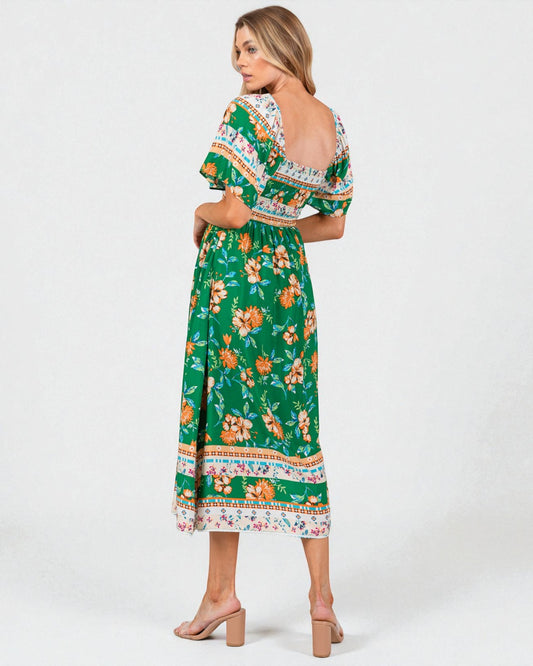 Woman wearing a green floral dress with a white background