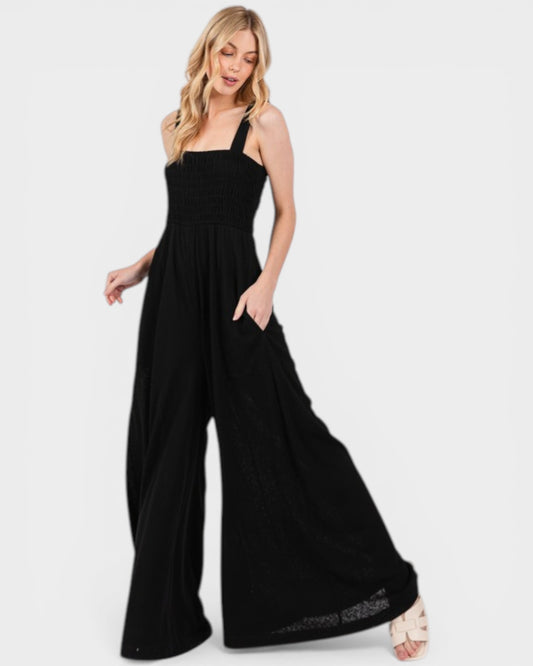 Woman wearing a black jumpsuit on a white background