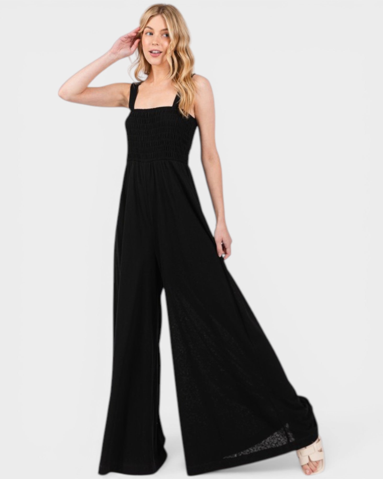 Woman wearing a black jumpsuit on a white background