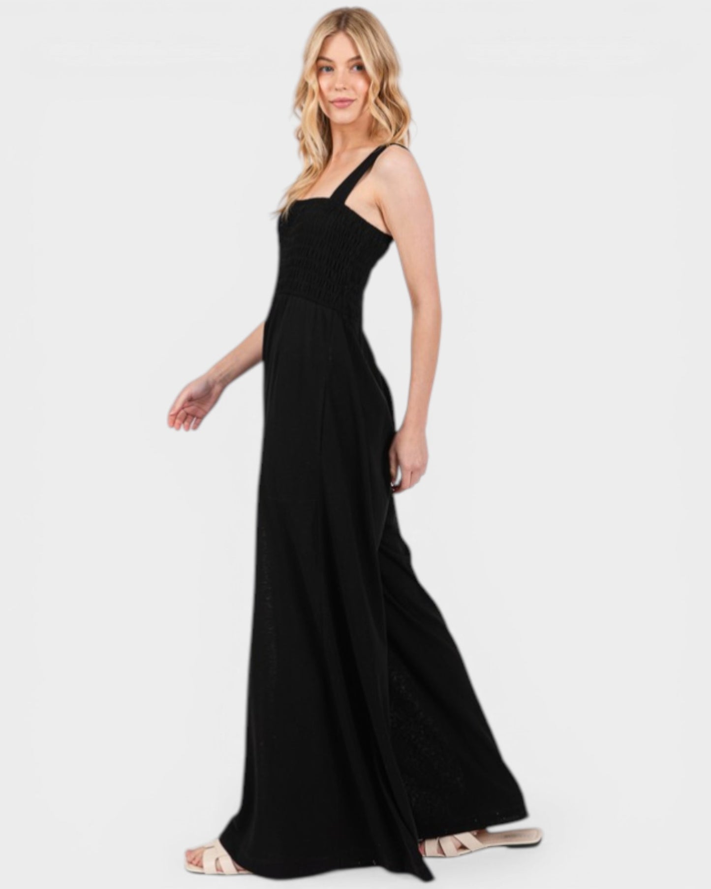 Woman wearing a black one-shoulder dress on a white background