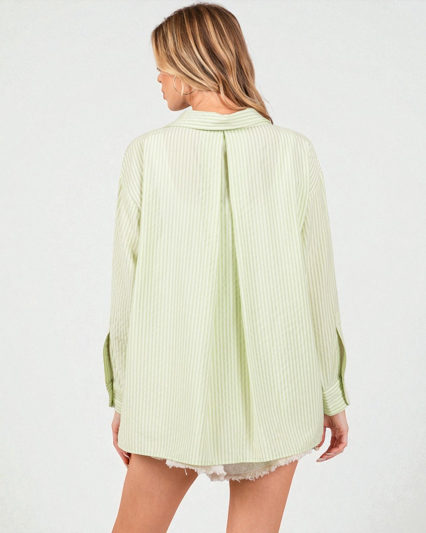 Light green ribbed long-sleeve top worn by a person on a white background