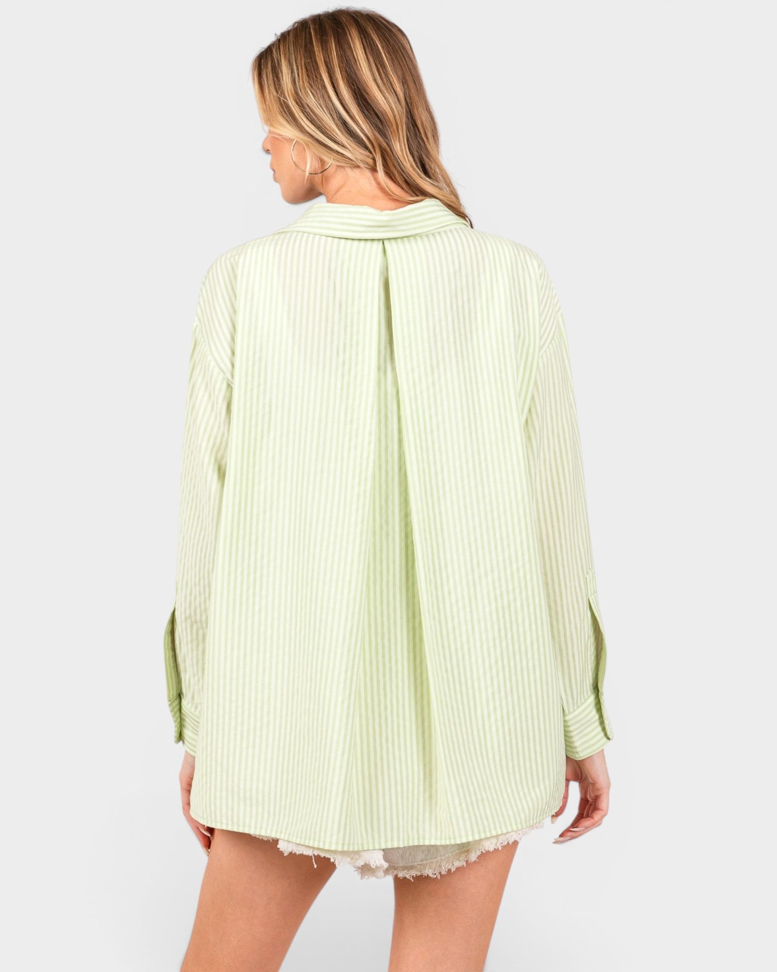 Light green ribbed sweater worn by a person on a white background