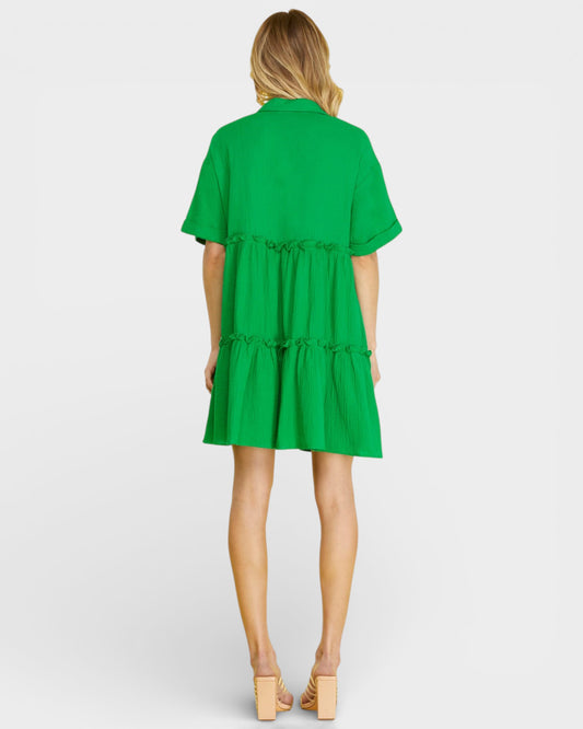 Green dress worn by a model on a white background