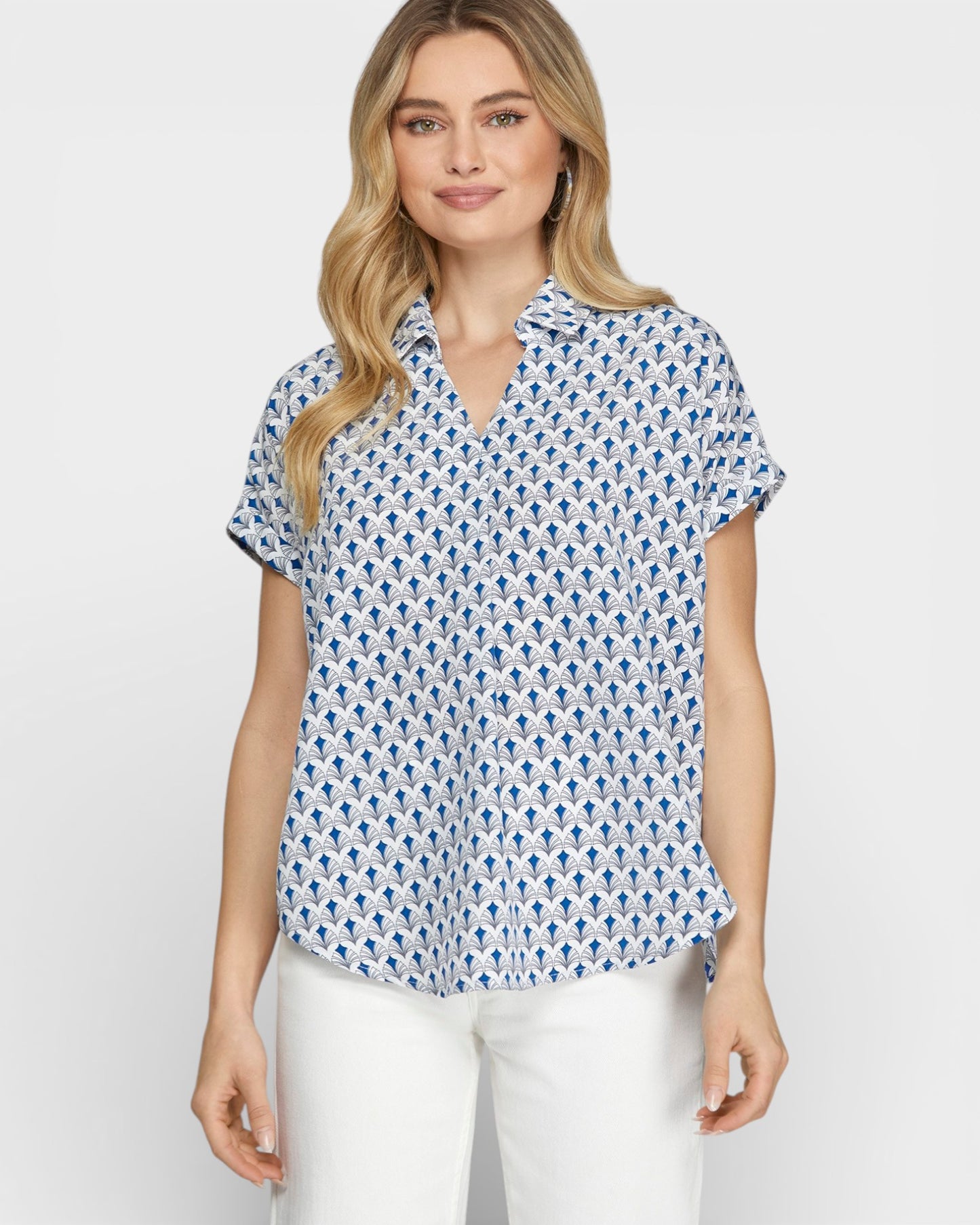 Woman wearing a blue and white patterned blouse on a white background