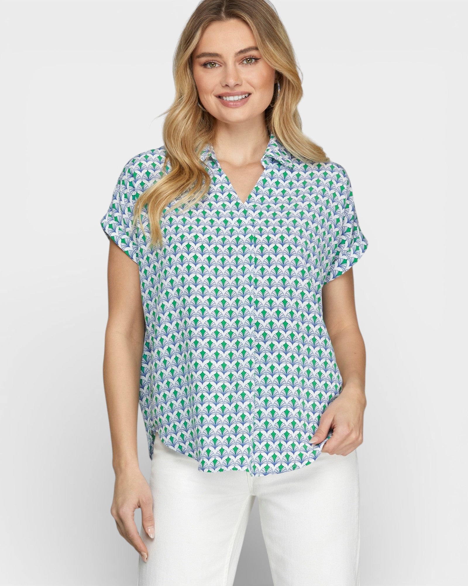 Woman wearing a patterned shirt with a plain background