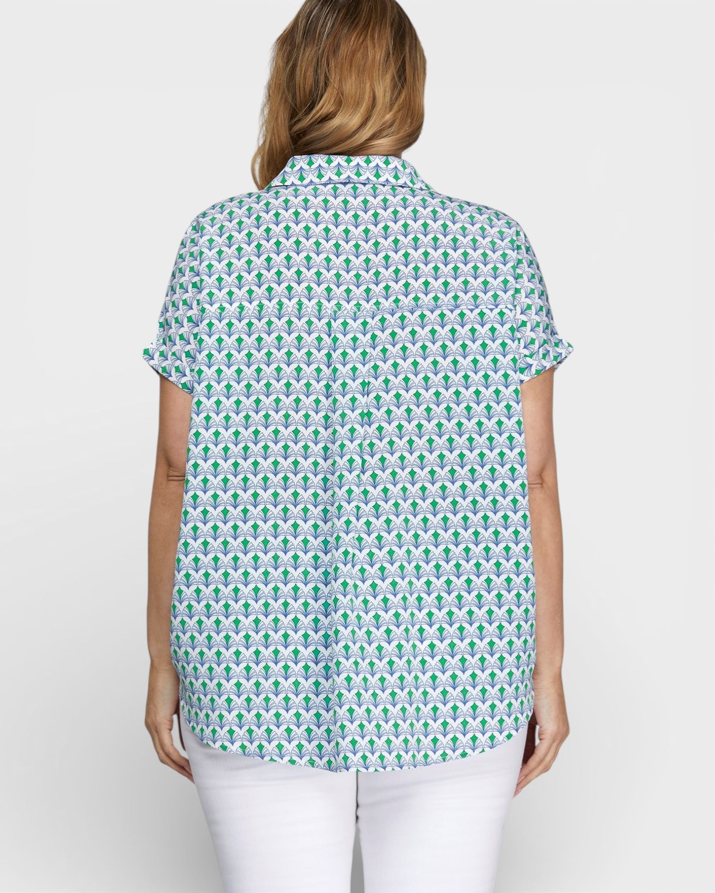 Woman wearing a patterned shirt on a white background
