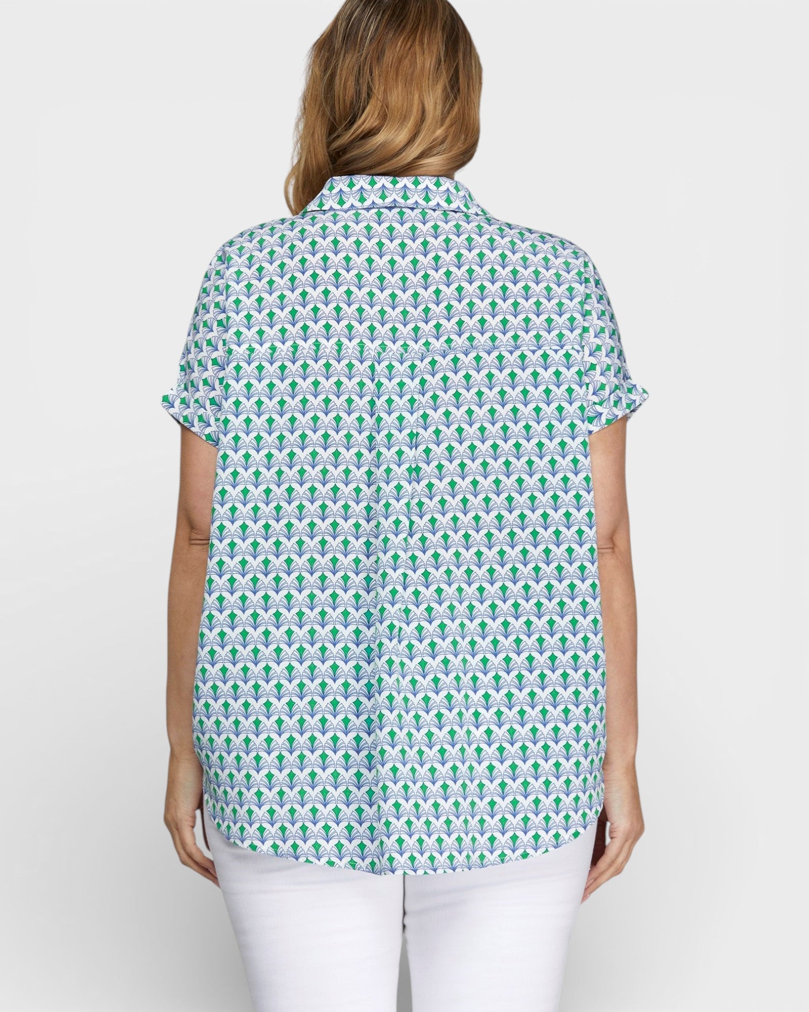 Woman wearing a patterned shirt on a white background