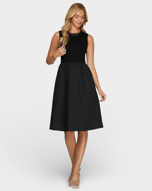 Woman wearing a black sleeveless dress on a white background