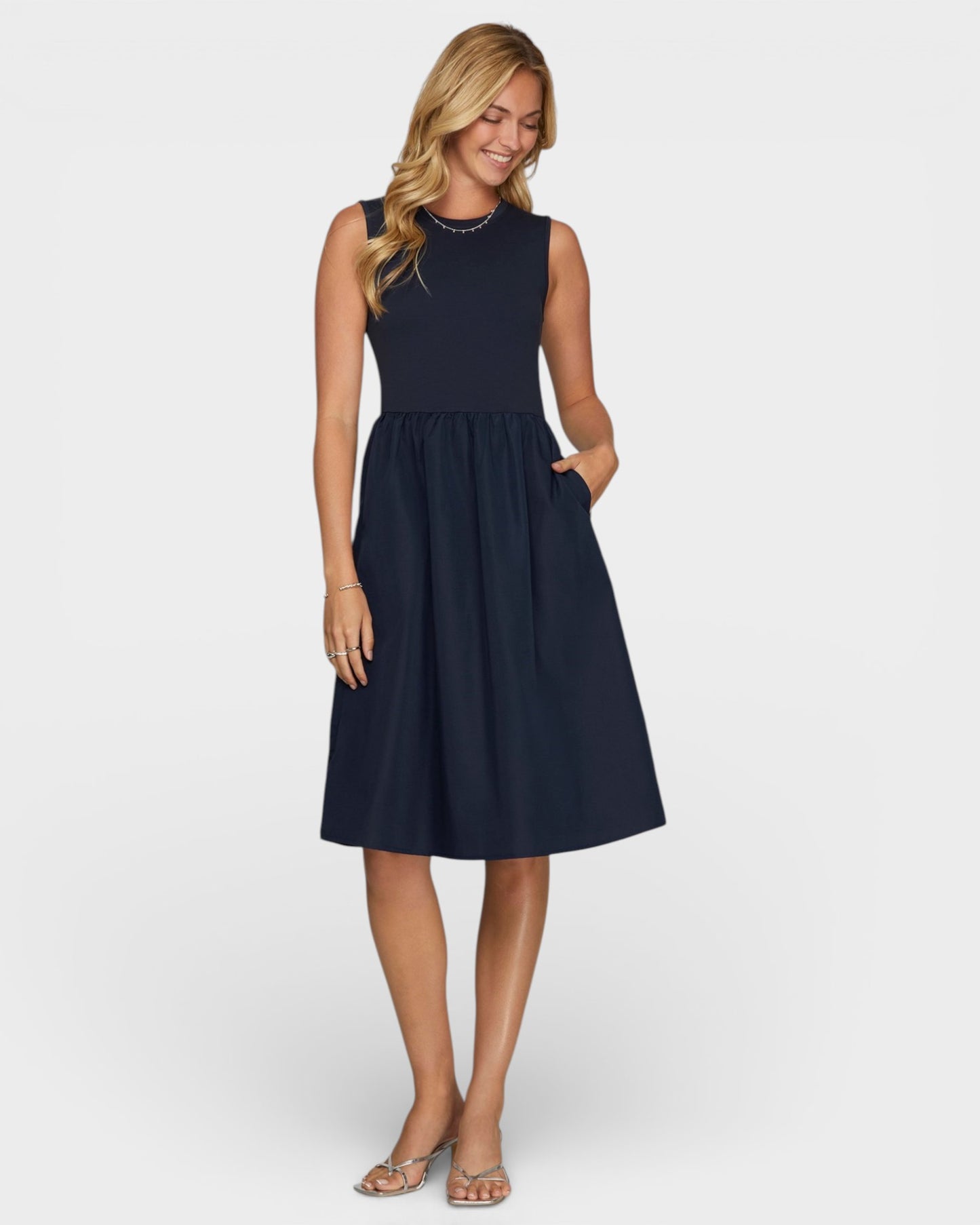 Woman wearing a navy blue dress on a white background