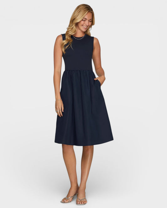 Woman wearing a navy blue dress on a white background