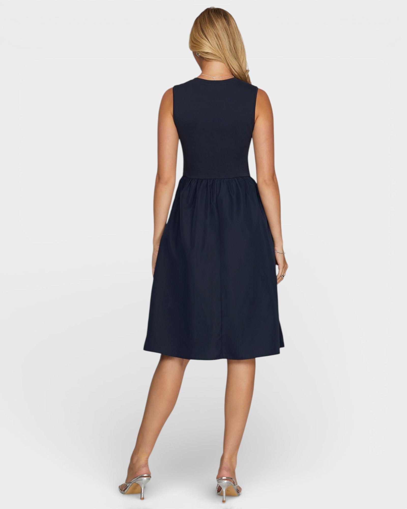 Woman wearing a navy blue dress on a white background