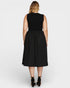 Woman wearing a black sleeveless dress on a white background