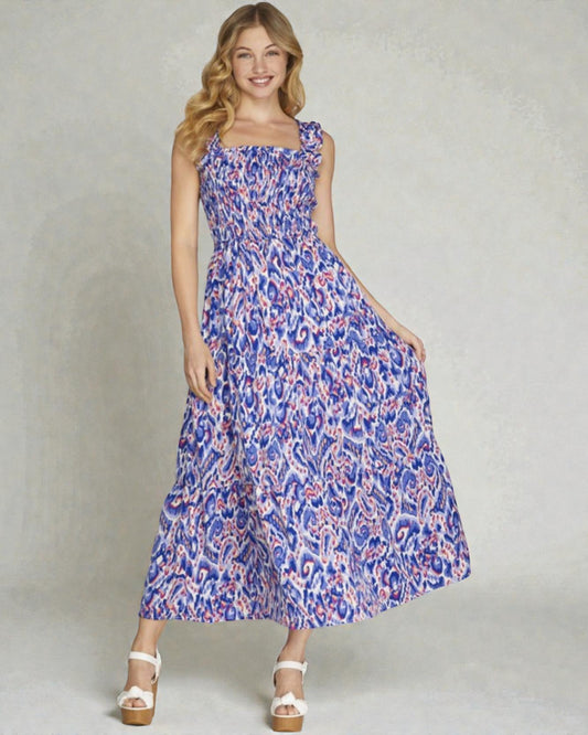 Woman wearing a blue floral dress on a plain background