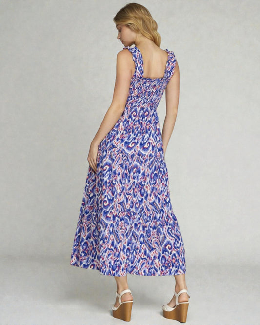 Woman wearing a blue floral dress on a plain background