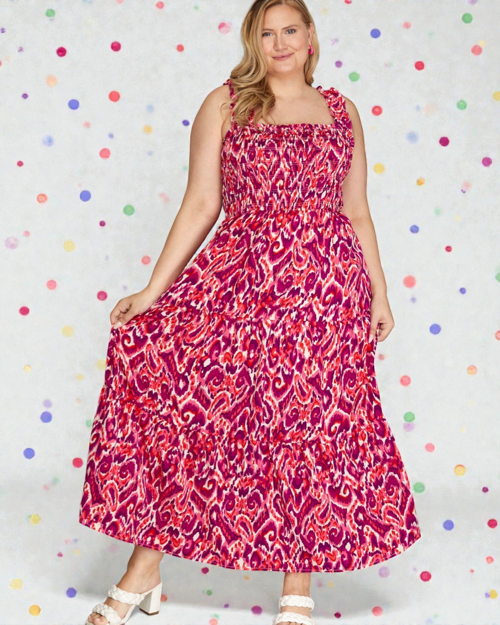 Woman wearing a pink patterned dress against a polka dot background