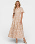 Woman wearing a beige floral dress on a white background