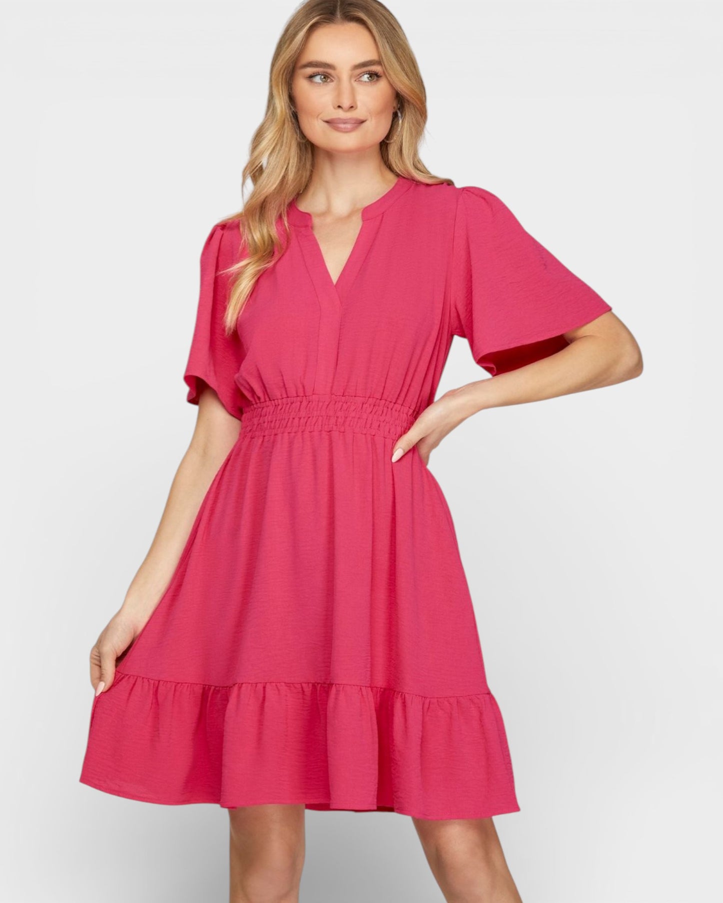 Woman wearing a pink dress against a white background