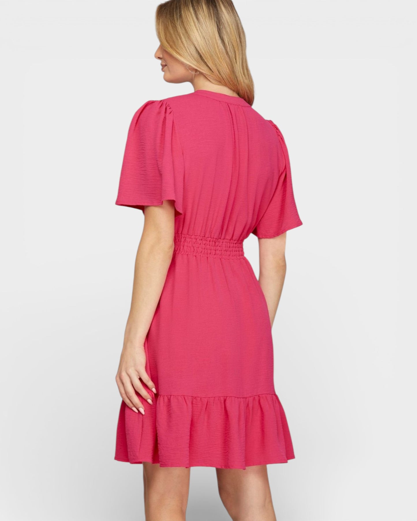 Woman wearing a pink dress on a white background