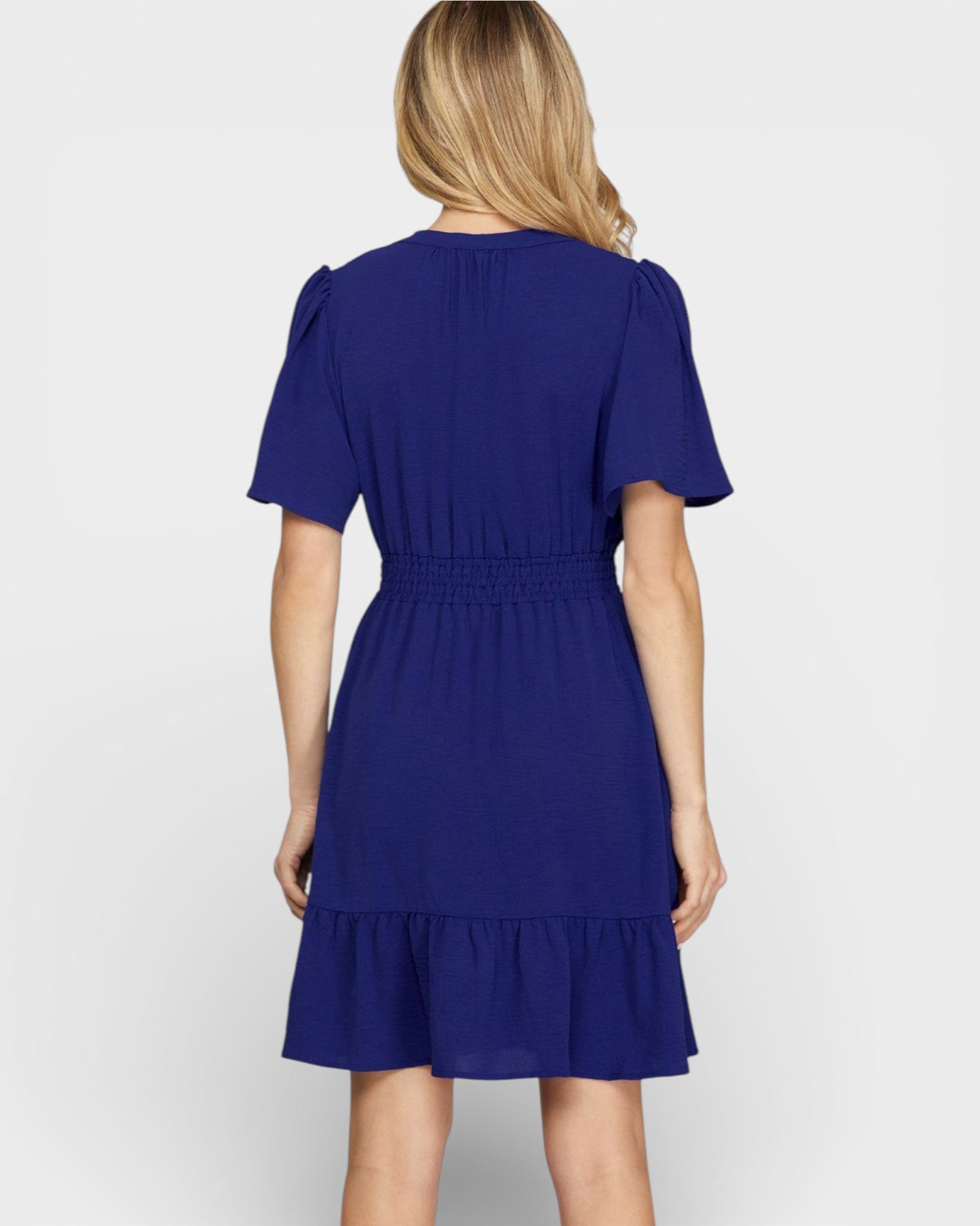 Woman wearing a blue dress on a white background