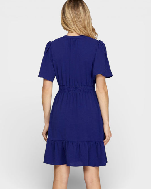 Woman wearing a blue dress on a white background