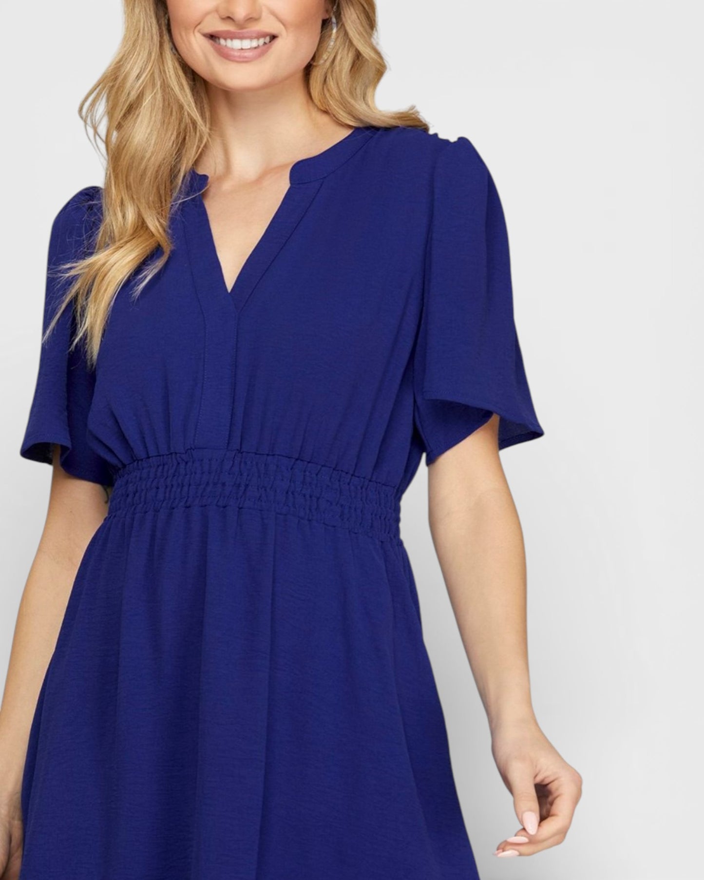 Woman wearing a blue dress on a white background