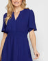 Woman wearing a blue dress on a white background