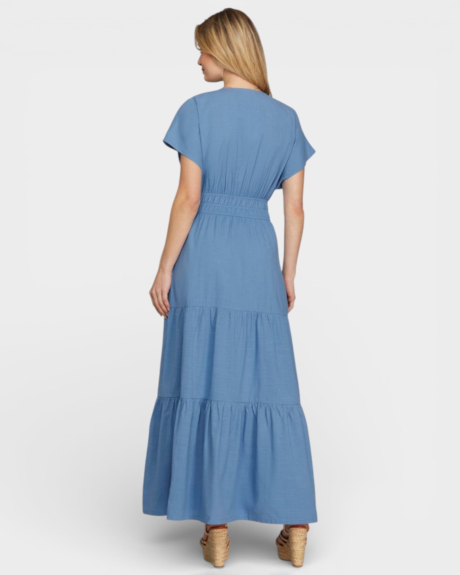 Woman wearing a blue dress with a white background