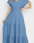Blue tiered dress worn by a person on a white background