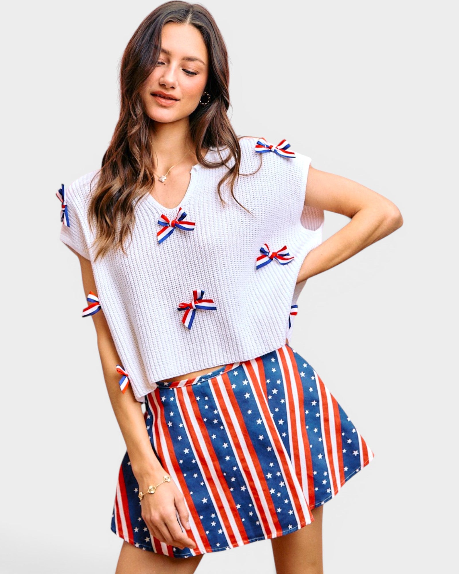 woman wearing white blouse with red white and blue bows