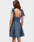 Blue denim dress with bow straps on a white background