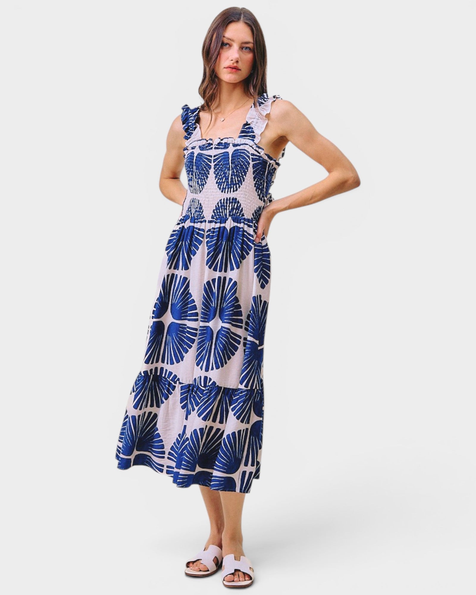 Woman wearing a blue and white patterned dress on a white background