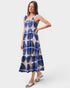 Woman wearing a blue and white patterned dress on a white background