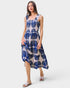 Woman wearing a blue and white patterned dress on a white background