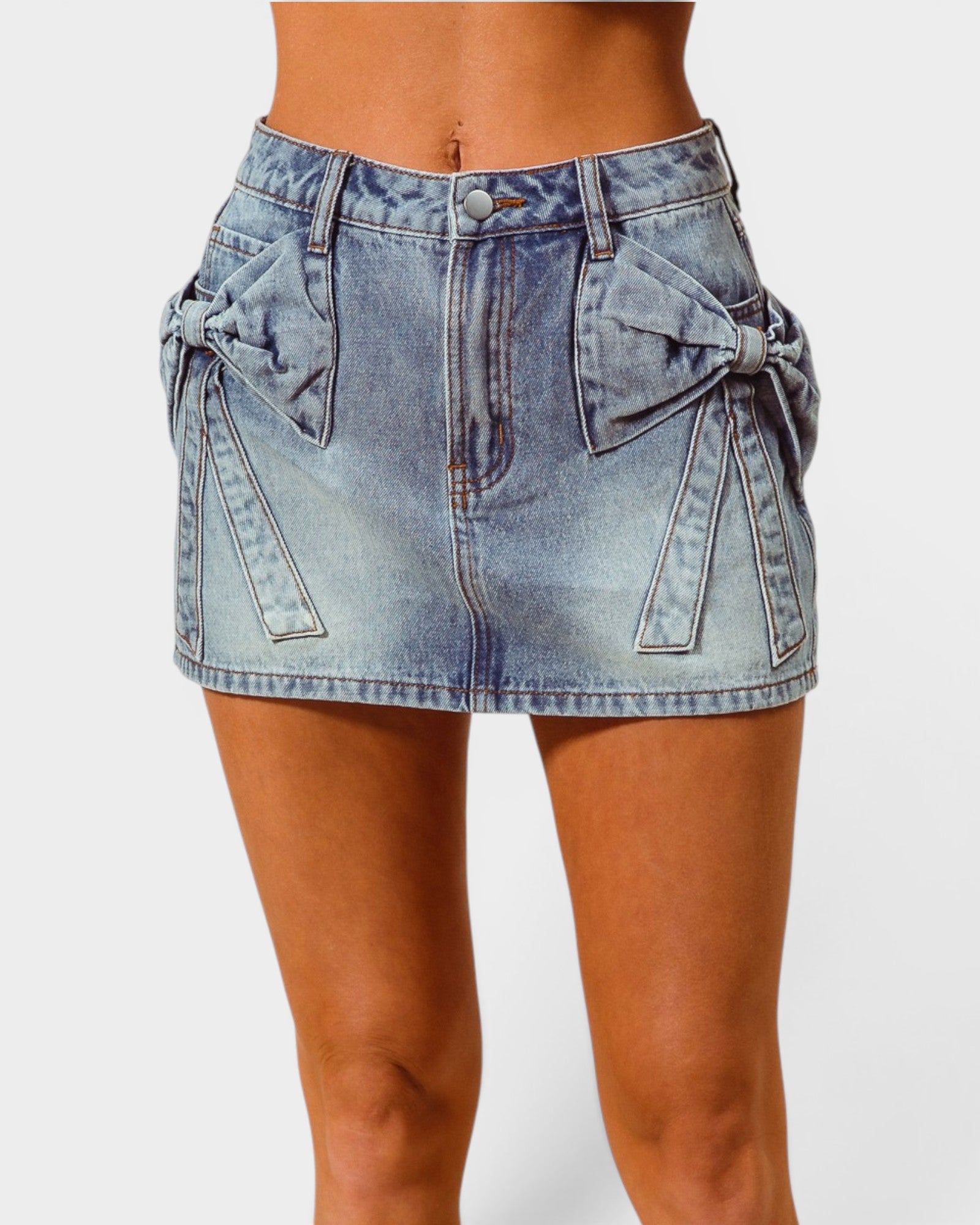 Denim skirt with bow details on a white background