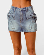Denim skirt with bow details on a white background