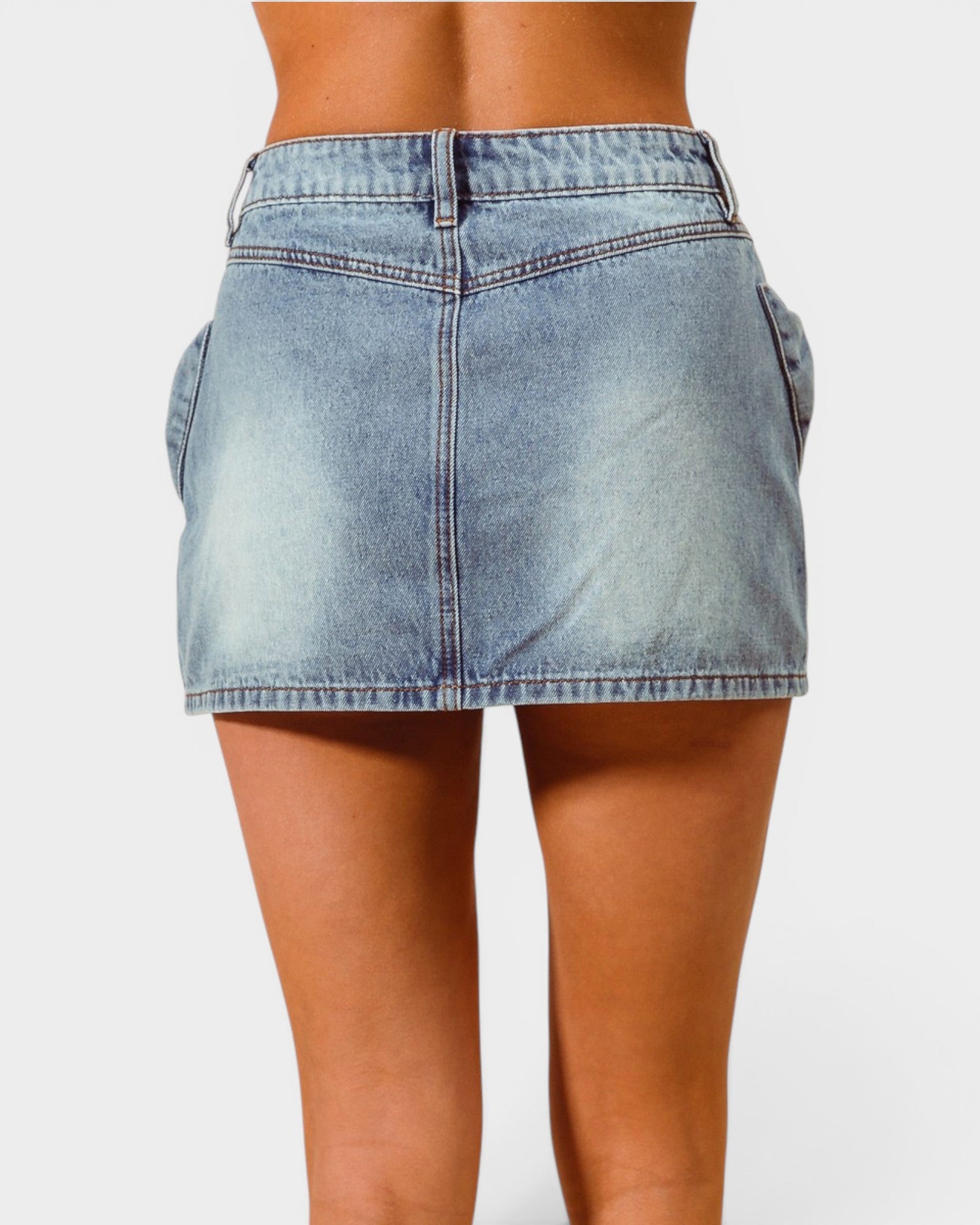 Light blue denim skirt worn by a person on a white background