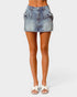 Denim skirt worn by a person on a white background