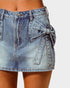 Denim skirt with a bow detail on a plain background