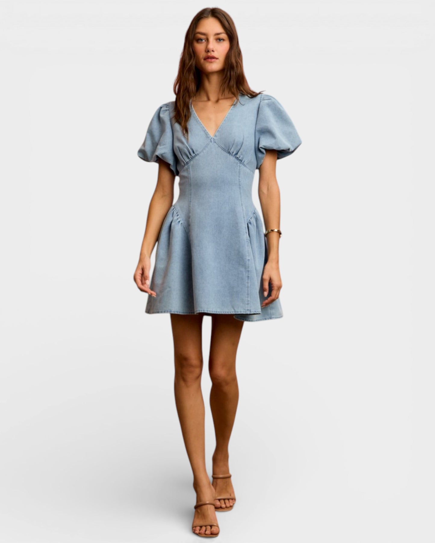 Woman wearing a light blue dress on a white background