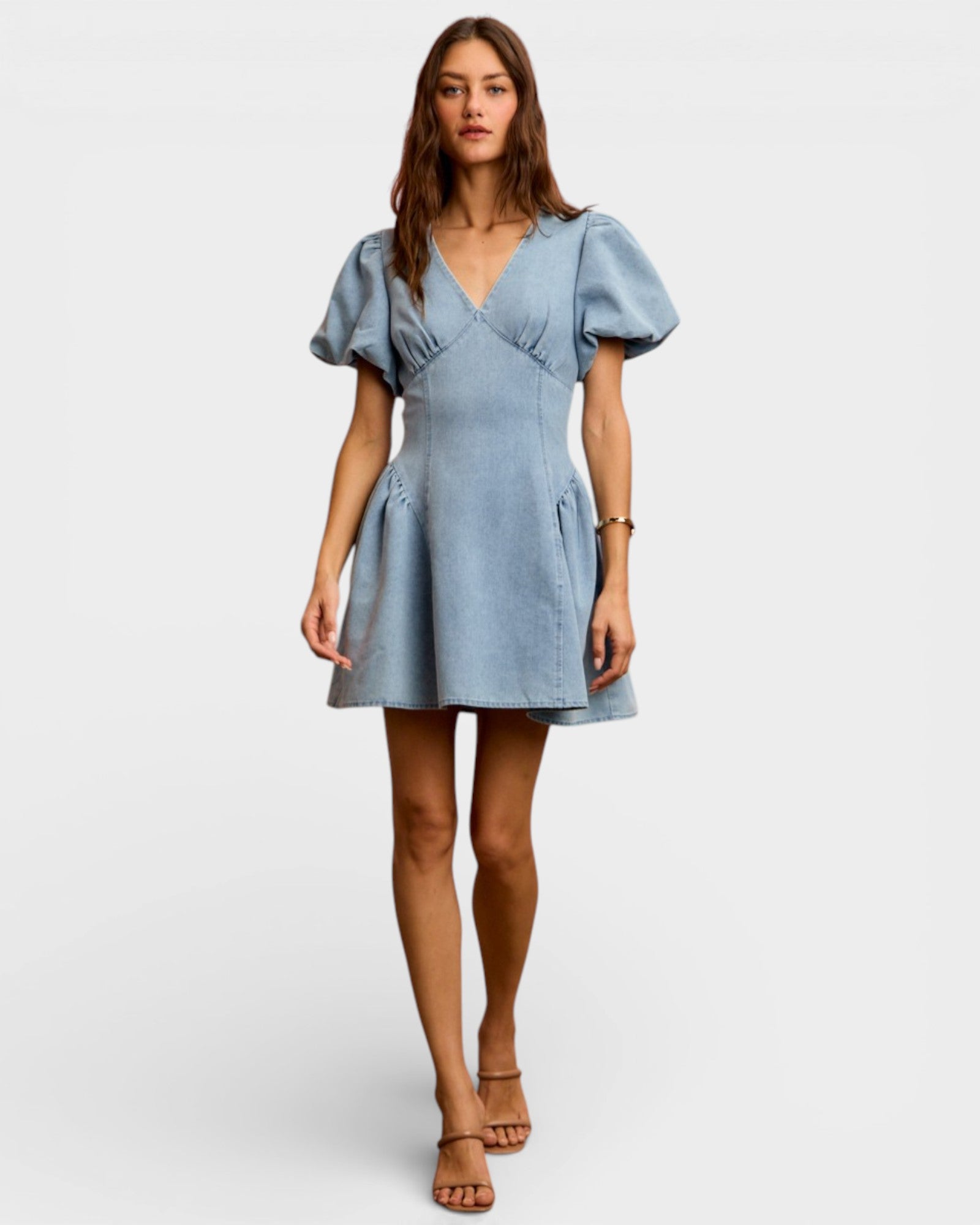 Woman wearing a light blue dress on a white background