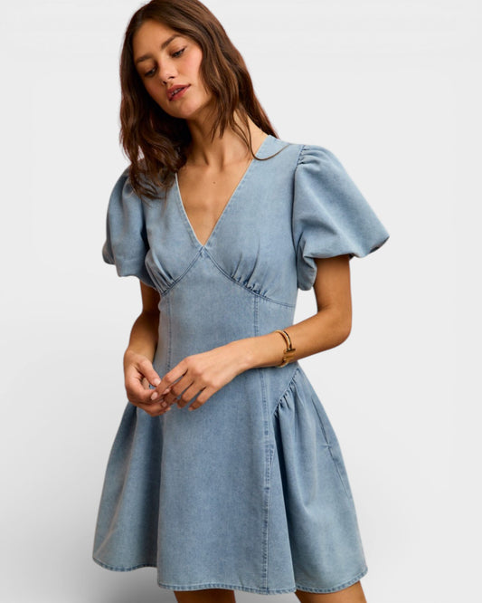 Woman wearing a light blue dress on a white background