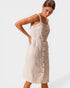 Woman wearing a beige button-up dress on a white background