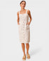 Woman wearing a beige button-up dress on a white background