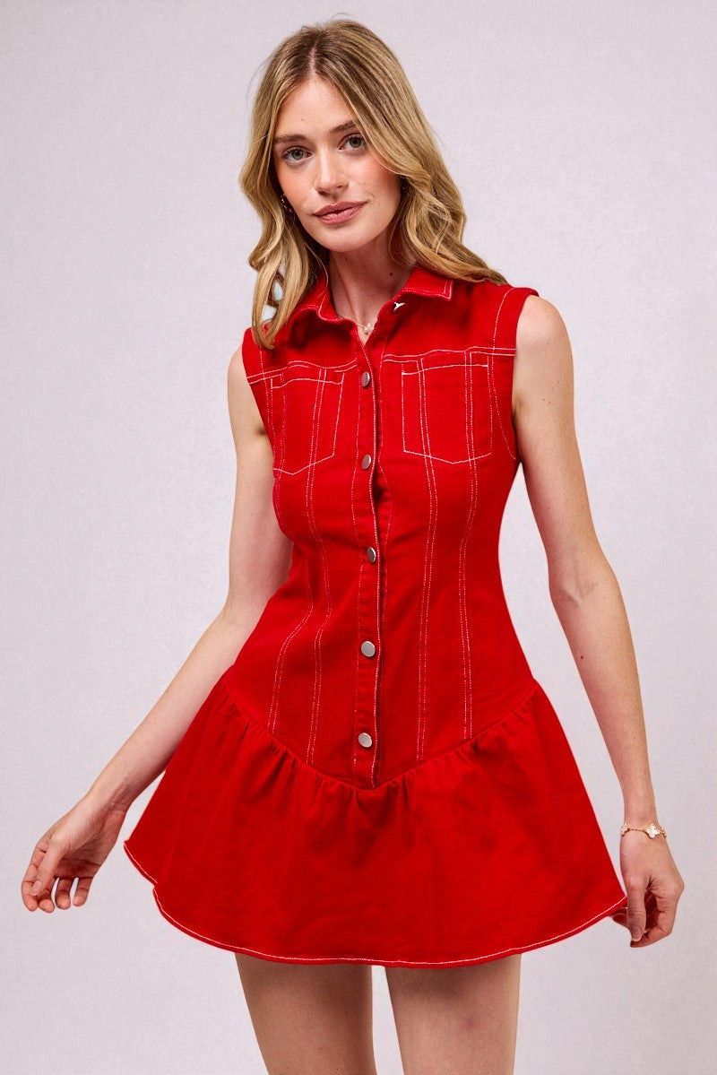 Woman wearing a red dress with white buttons on a light gray background