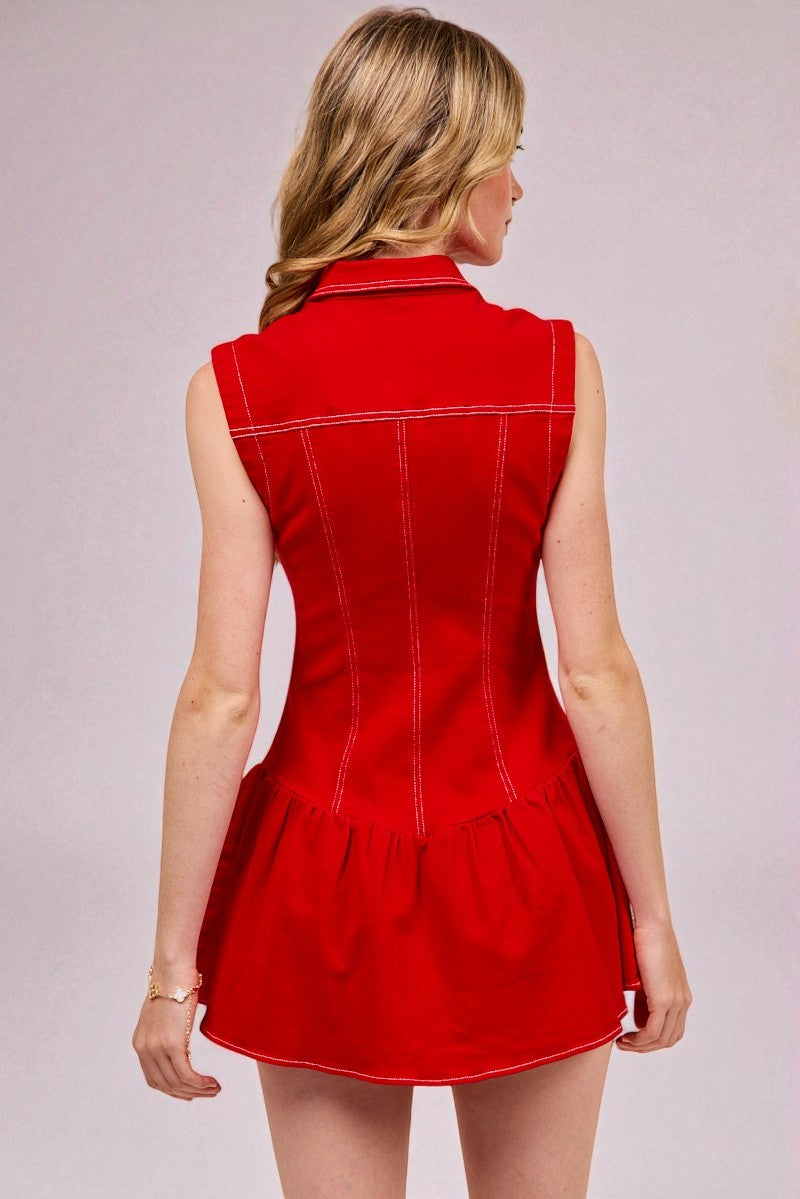 Red dress with white trim worn by a person on a plain background