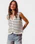 Woman wearing a striped sleeveless top and denim shorts on a white background