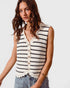Woman wearing a striped sleeveless top with a plain background