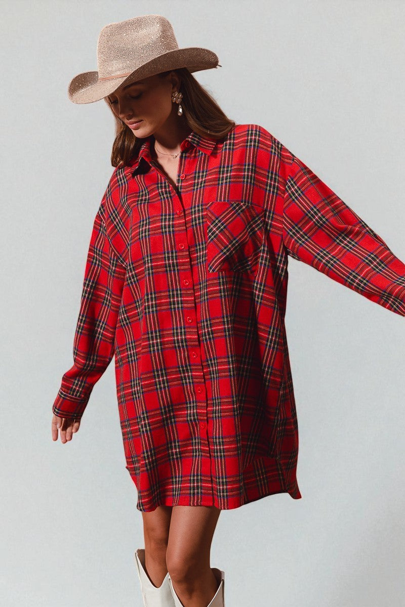 Woman wearing a red plaid dress with a beige hat and white boots on a light gray background