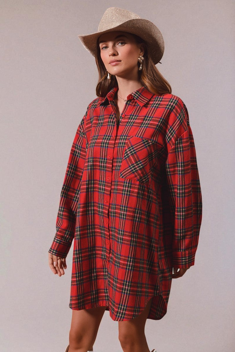 Woman wearing a red plaid dress and cowboy hat against a plain background